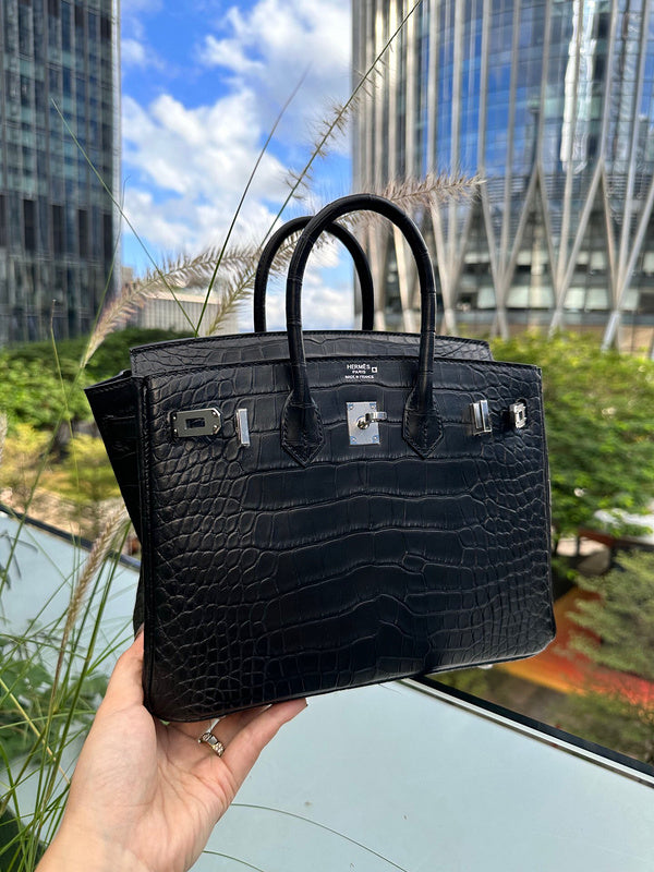 Side view of sculpted structured handbag