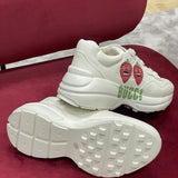 Side profile of Gucci soft grey sneakers bold athletic profile