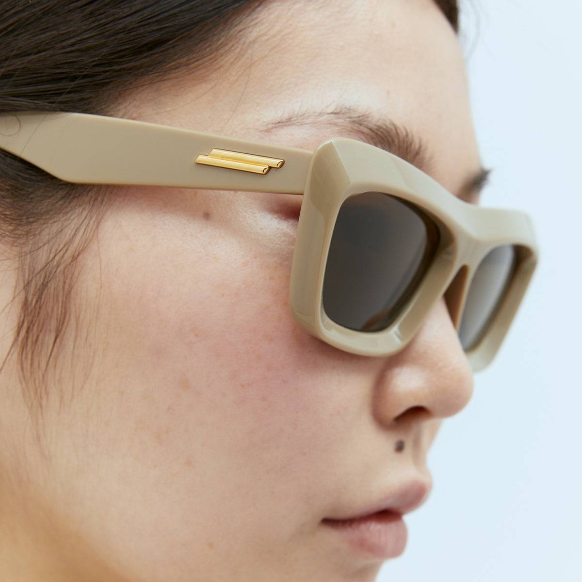 Close-up of Bottega Veneta sunglasses hardware and fine stitching