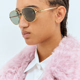 Close-up of Bottega Veneta sunglasses hardware and fine stitching
