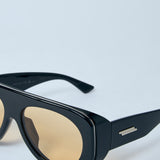 Close-up of Bottega Veneta sunglasses hardware and fine stitching