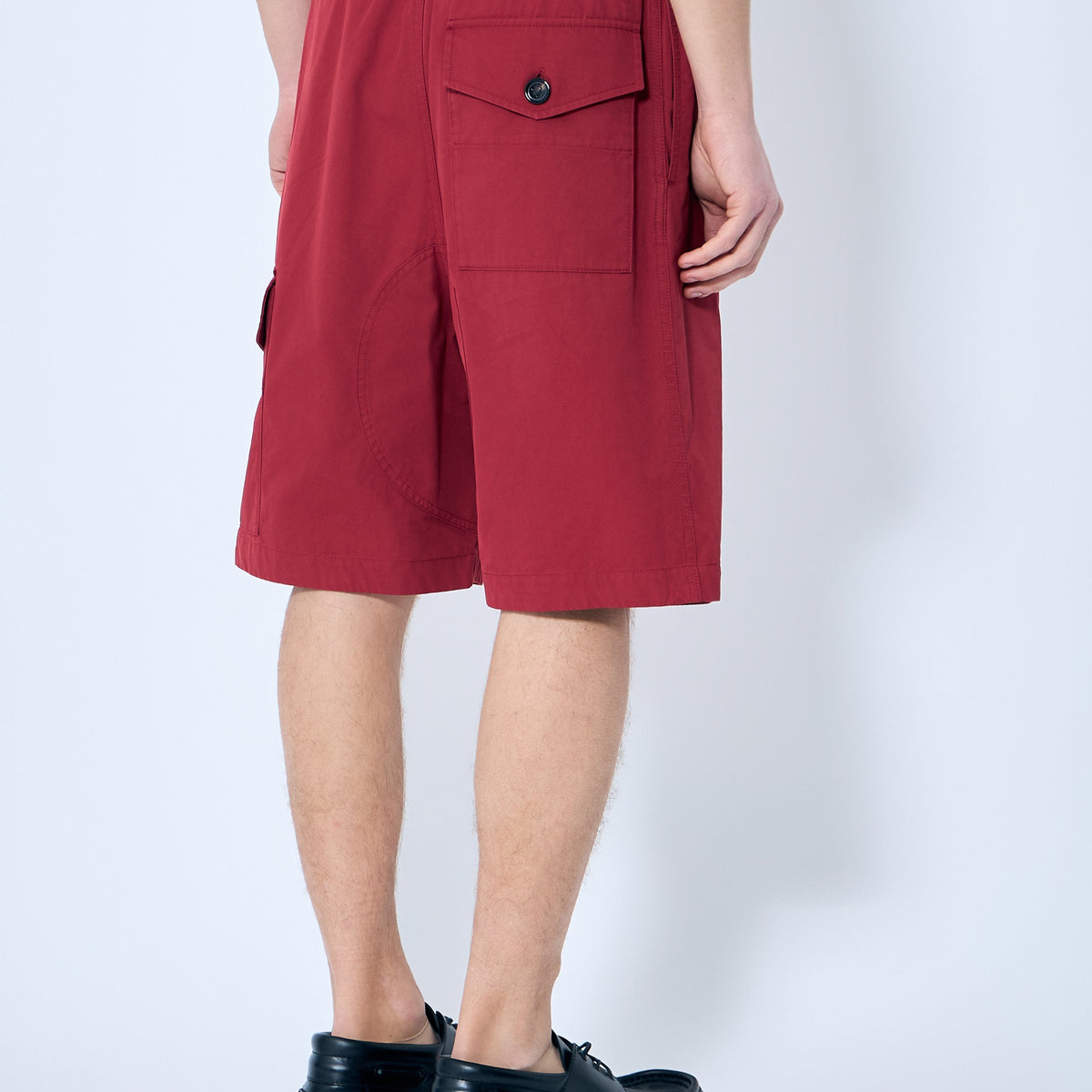 Close-up of Bottega Veneta pants hardware and fine stitching