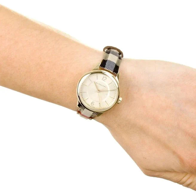 Angled view of Burberry women's gold watch
