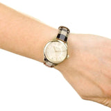 Angled view of Burberry women's gold watch