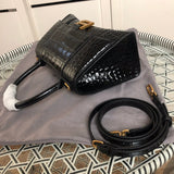Styled lifestyle shot of classic sleek women's handbag – women's luxury accessory