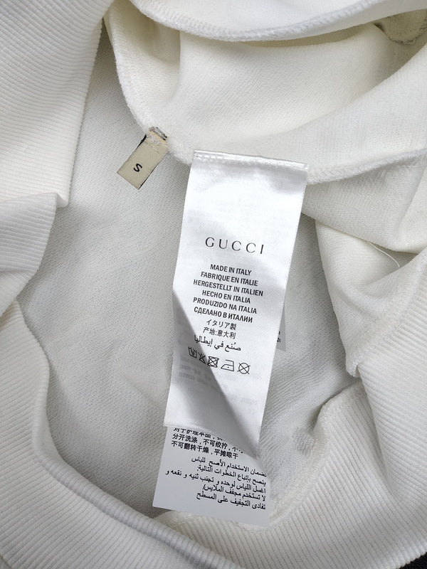 Back view of Gucci luxury clothing with label-forward styling