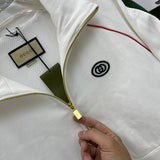 Close-up detail shot of Gucci luxury clothing with label-forward styling