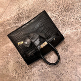  Tailored handbag carried on shoulder