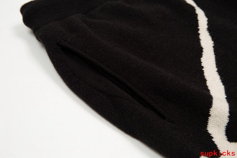 Side profile of Rhude luxury clothing with monogram-inspired silhouette