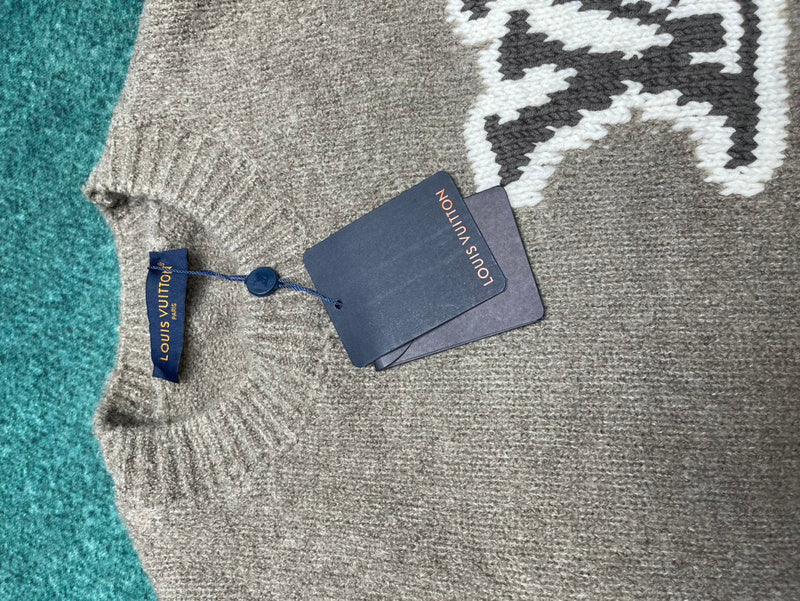 Flat lay presentation of Louis Vuitton luxury clothing with label-forward styling