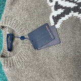 Flat lay presentation of Louis Vuitton luxury clothing with label-forward styling