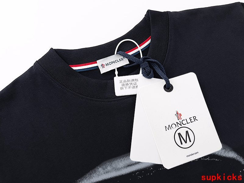 Close-up detail shot of Moncler luxury clothing with monogram-inspired silhouette