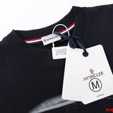Close-up detail shot of Moncler luxury clothing with monogram-inspired silhouette