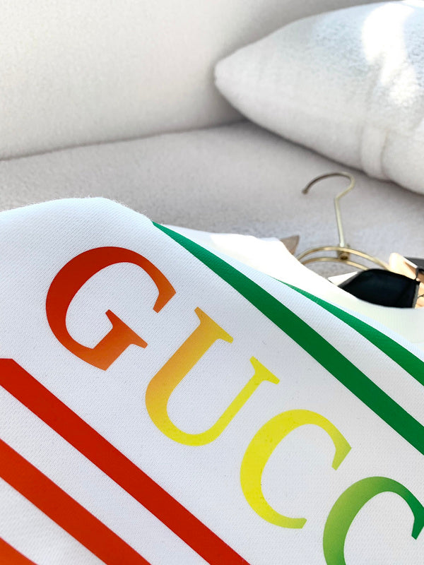 Close-up detail shot of Gucci luxury clothing with monogram-inspired silhouette