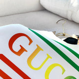 Close-up detail shot of Gucci luxury clothing with monogram-inspired silhouette