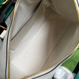 Side profile of classic signature women's handbag – women's designer-style accessory