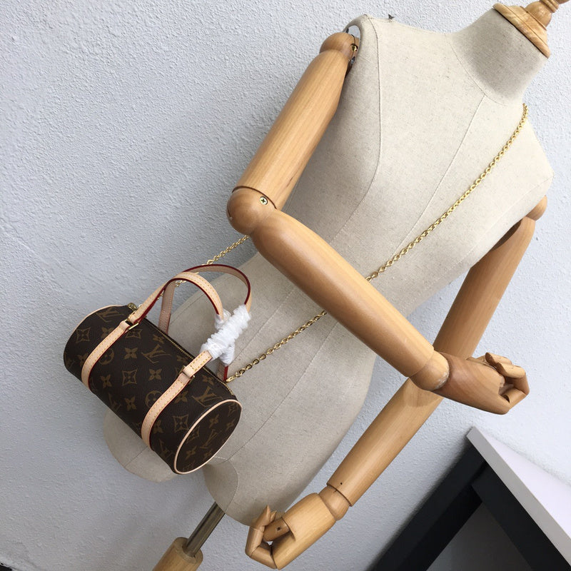 Side profile of polished signature women's handbag – women's luxury accessory