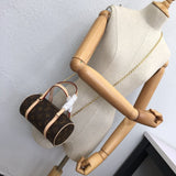 Side profile of polished signature women's handbag – women's luxury accessory