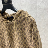 Close-up detail shot of Louis Vuitton luxury clothing with logo-detail design