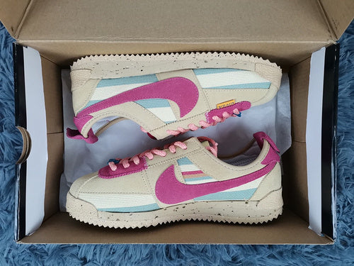 Nike Streetwear sneakers in neutral cream breathable knit upper front view
