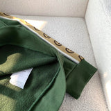 Close-up detail shot of Gucci luxury clothing with logo-detail design