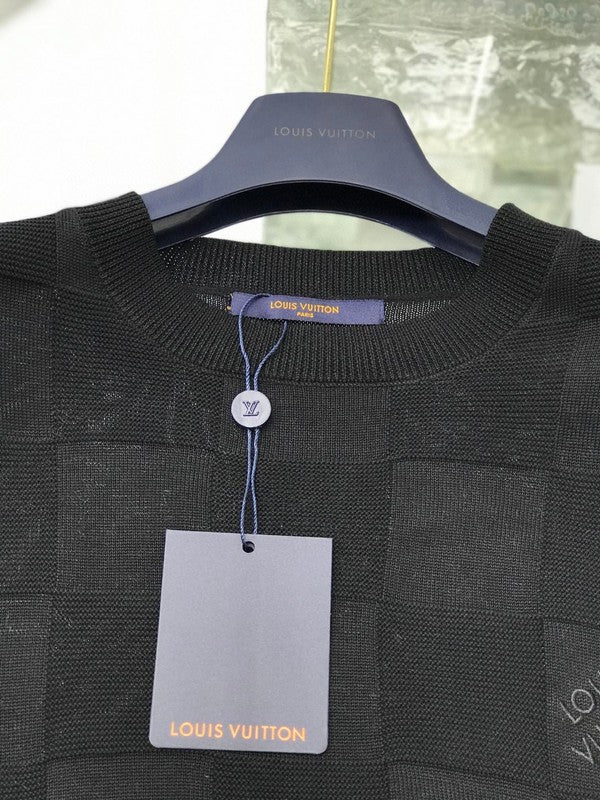 Flat lay presentation of Louis Vuitton luxury clothing with signature branding