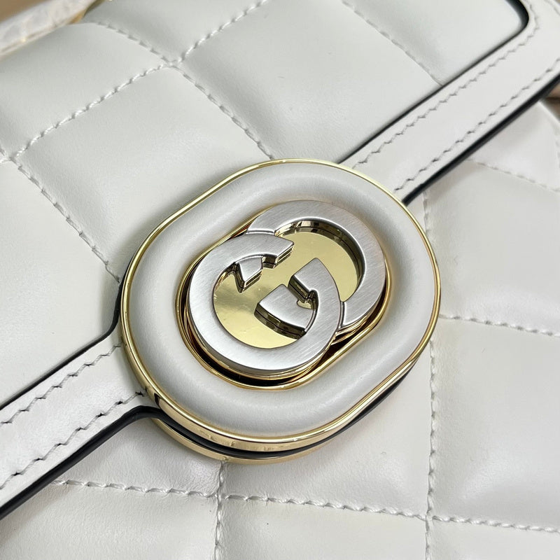Back view of classic polished women's handbag – women's statement bag