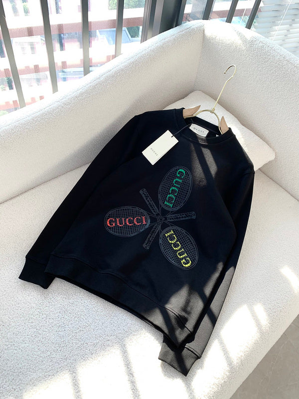Flat lay presentation of Gucci luxury clothing with monogram-inspired silhouette