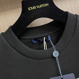 Close-up detail shot of Louis Vuitton luxury clothing with logo-detail design