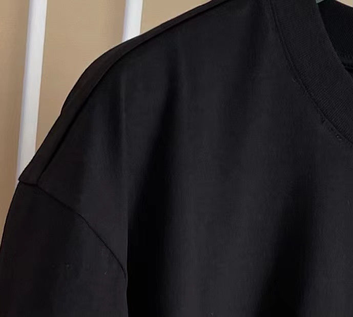 Close-up detail shot of Givenchy luxury clothing with monogram-inspired silhouette