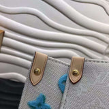 Handle and strap detail of everyday-luxe polished women's handbag – women's statement bag