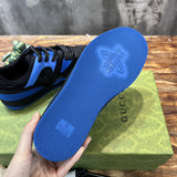 Side profile of Gucci classic monochrome sneakers retro runner design
