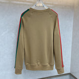 Close-up detail shot of Gucci luxury clothing with monogram-inspired silhouette