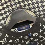 Flat lay presentation of Louis Vuitton luxury clothing with label-forward styling