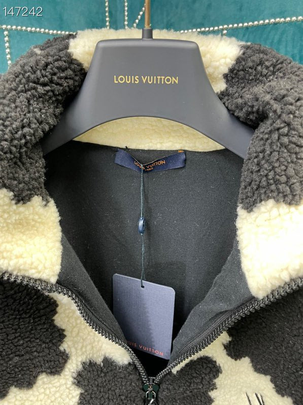 Close-up detail shot of Louis Vuitton luxury clothing with signature branding
