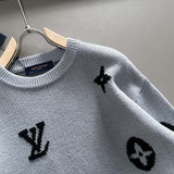 Close-up detail shot of Louis Vuitton luxury clothing with signature branding