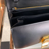 Side profile of elevated classic women's handbag – women's statement bag