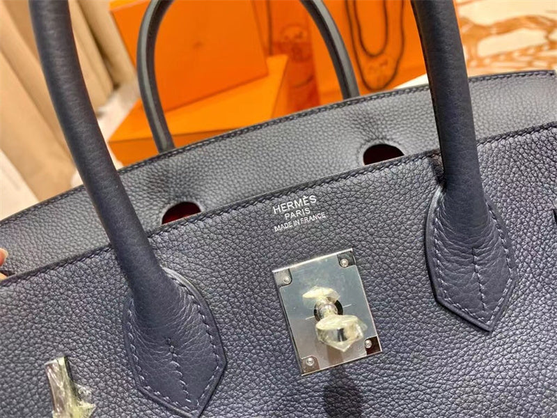 Side view of sleek structured handbag