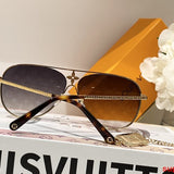 Close-up detail view of Louis Vuitton unisex sunglasses