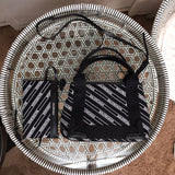 Side profile of chic polished women's handbag – women's luxury handbag