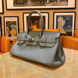  Signature top-handle bag carried on shoulder 10