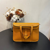  Clean-Lined top-handle bag carried on shoulder