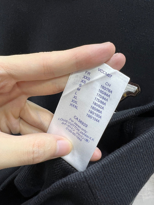 Side profile of Louis Vuitton luxury clothing with logo-detail design
