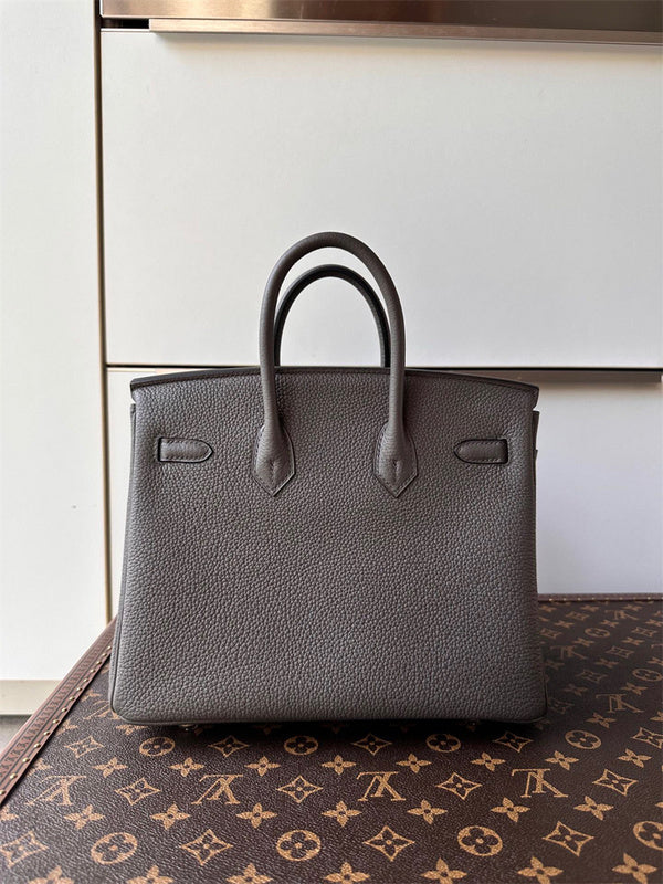  Classic top-handle bag carried on shoulder