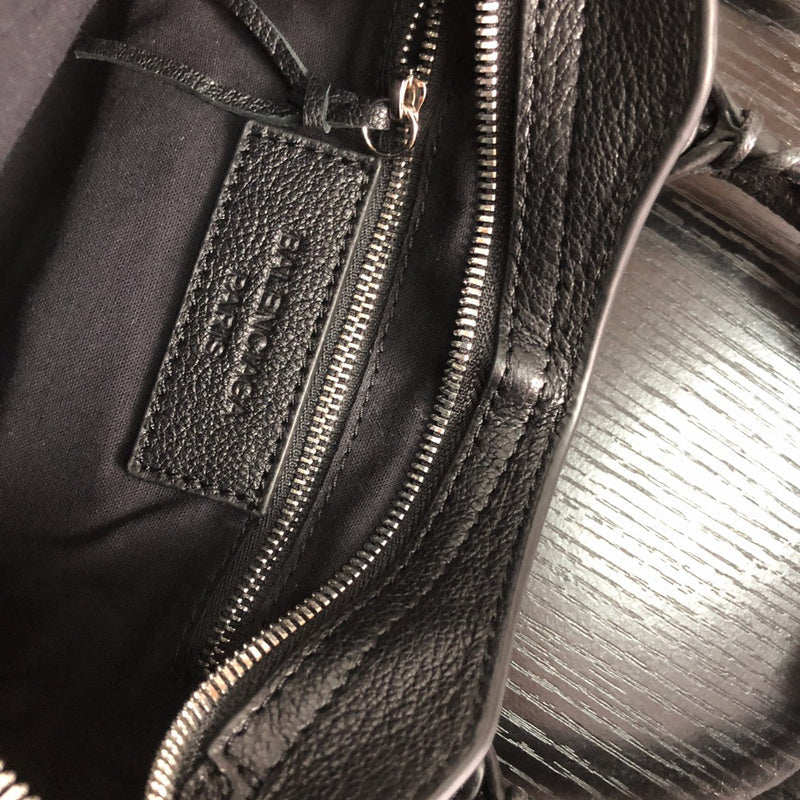 Side profile of elevated polished women's handbag – women's luxury accessory