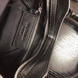 Side profile of elevated polished women's handbag – women's luxury accessory