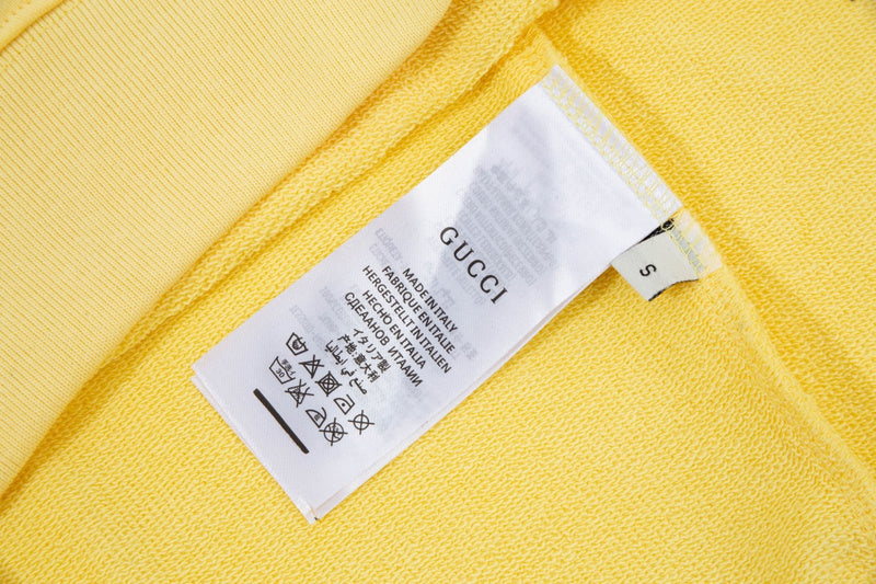 Close-up detail shot of Gucci luxury clothing with signature branding