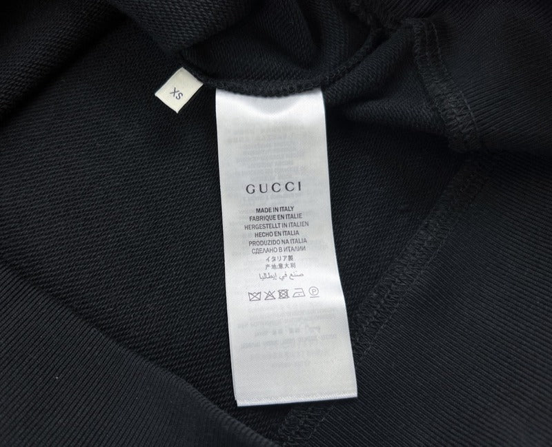 Side profile of Gucci luxury clothing with signature branding