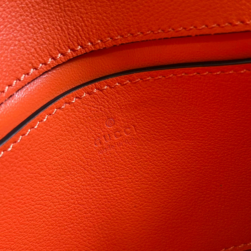 Side profile of sleek signature women's handbag – women's luxury accessory