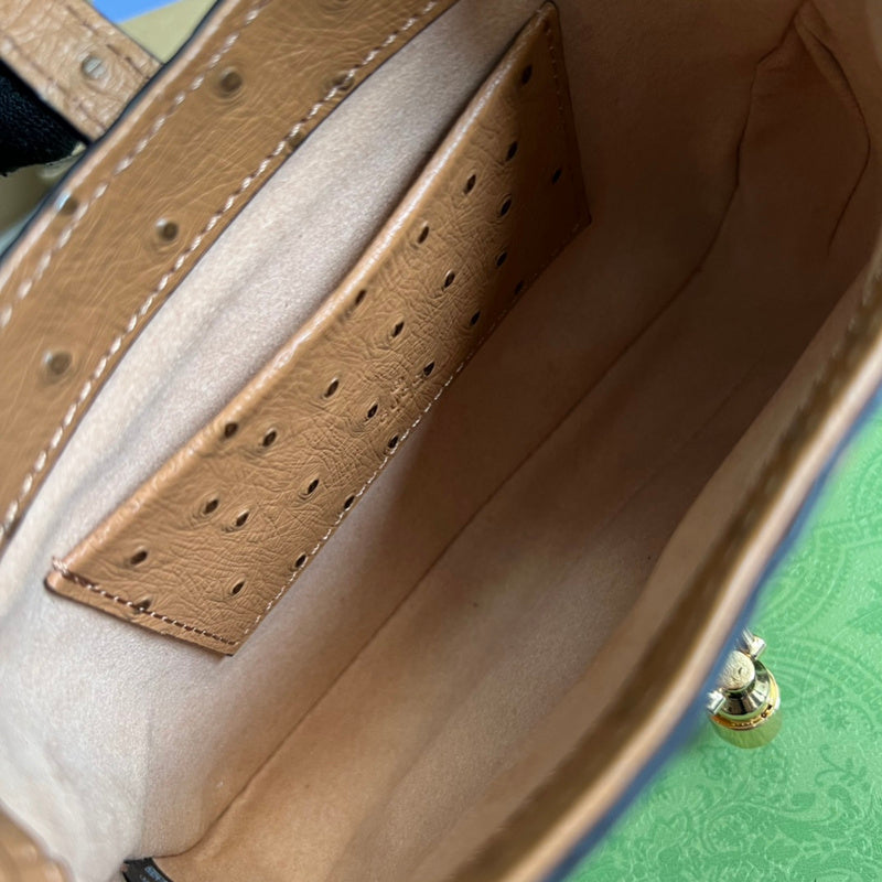 Side profile of refined signature women's handbag – women's luxury accessory